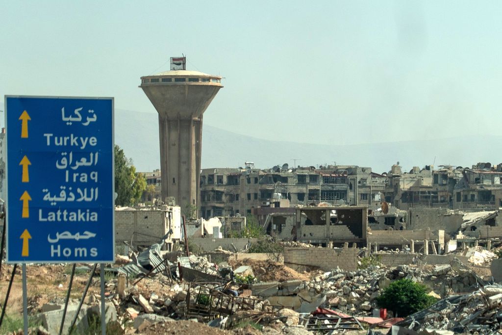 This picture shows destroyed buildings in Douma, a city northeast of the centre of Damascus on August 15, 2018. Photo by Andrei BORODULIN - AFP